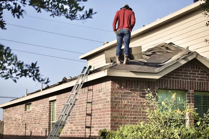 Professional roofer working on a residential roof in Marsteller